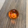 Kugel orange transparent mit eingelassenen roten Sternen 54 (2 1/8")